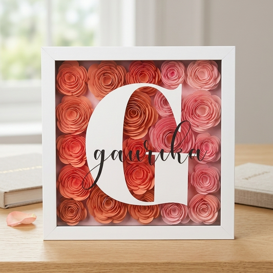 Decorative frame with red and pink rose petals and the name 'Gaurika' on a wooden surface.