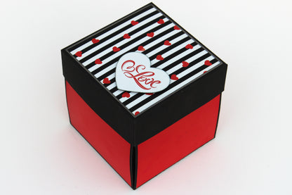 5 Star chocolate explosion box closed view with black and red striped lid and heart detail