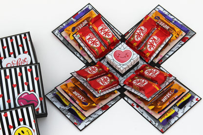 Chocolate explosion box with KitKat and 5 Star chocolates arranged inside layered panels